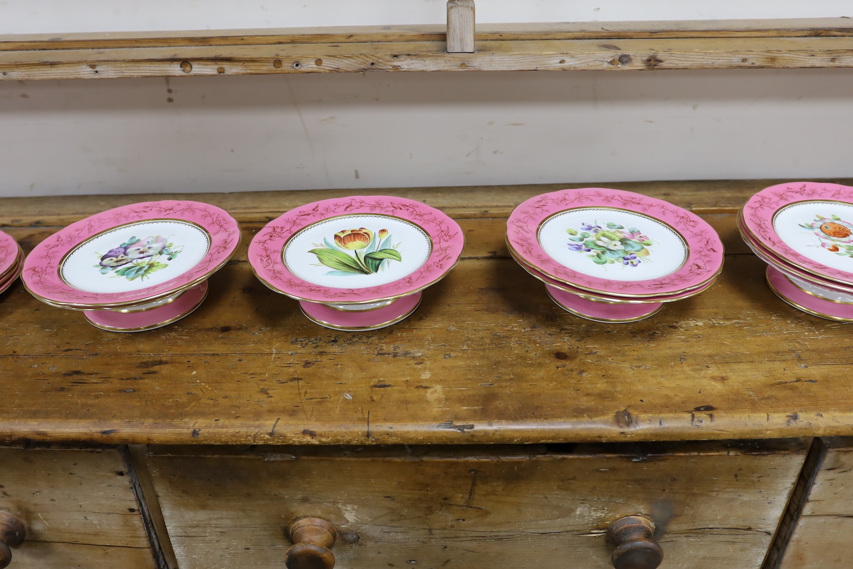 An English porcelain pink ground floral dessert service, late 19th century